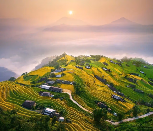 Terraced fields and mountain villages across a highland ridge in northern Vietnam