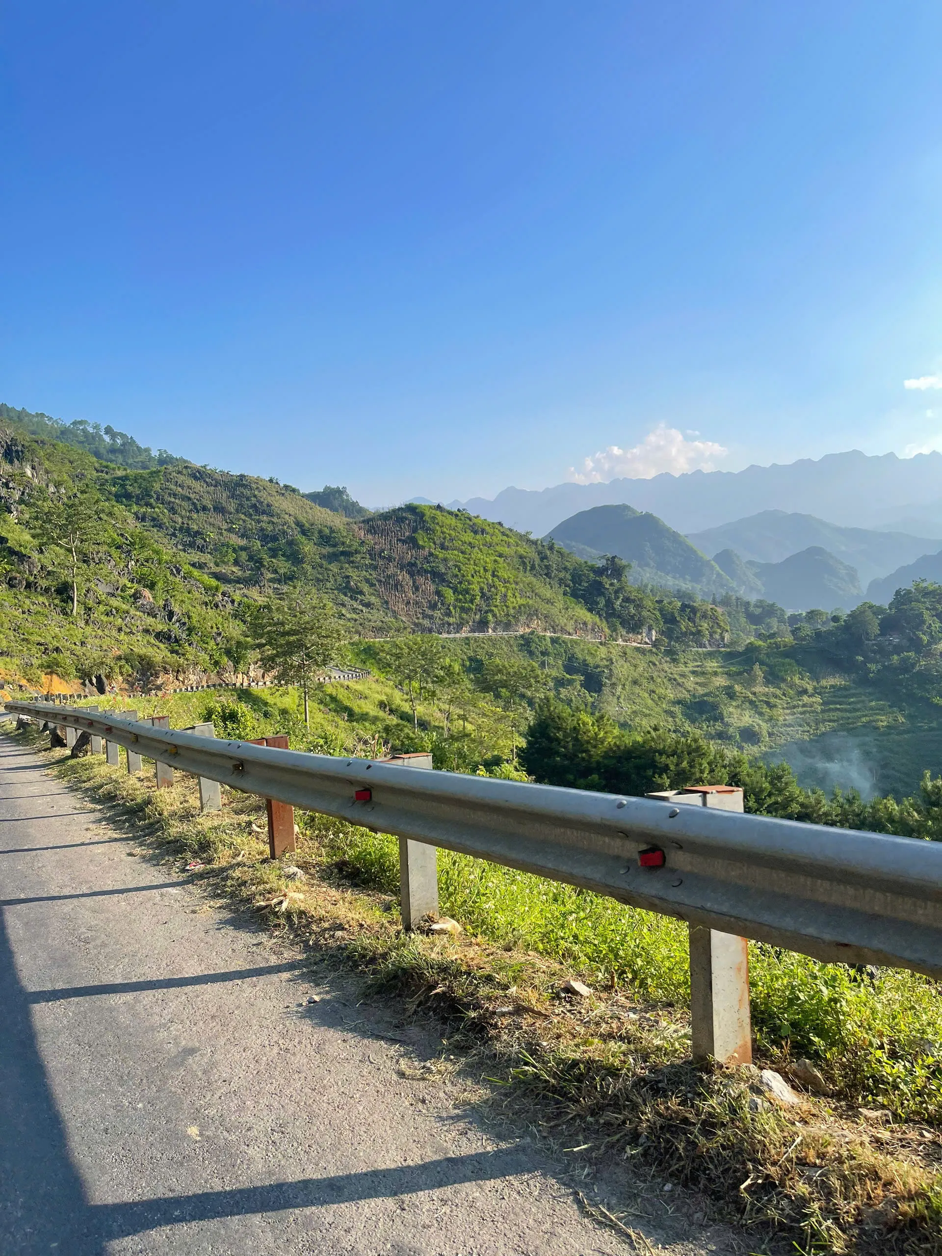 Mountain road and valley view in eastern Ha Giang — transfer context between walking zones.