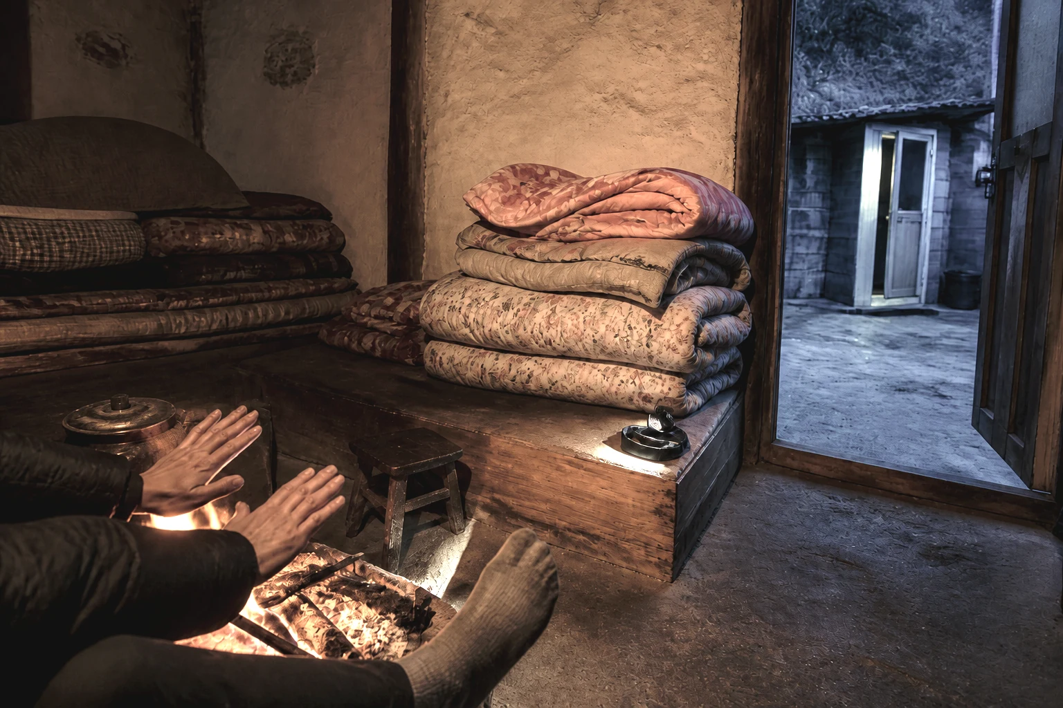 Hands warming over a hearth fire with stacked blankets in a northern plateau homestay room