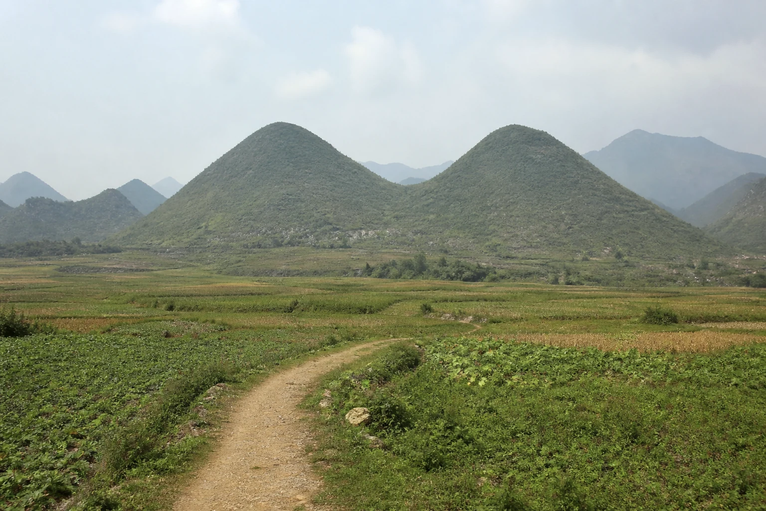 Quan Ba Twin Mountains above farmland and a valley path