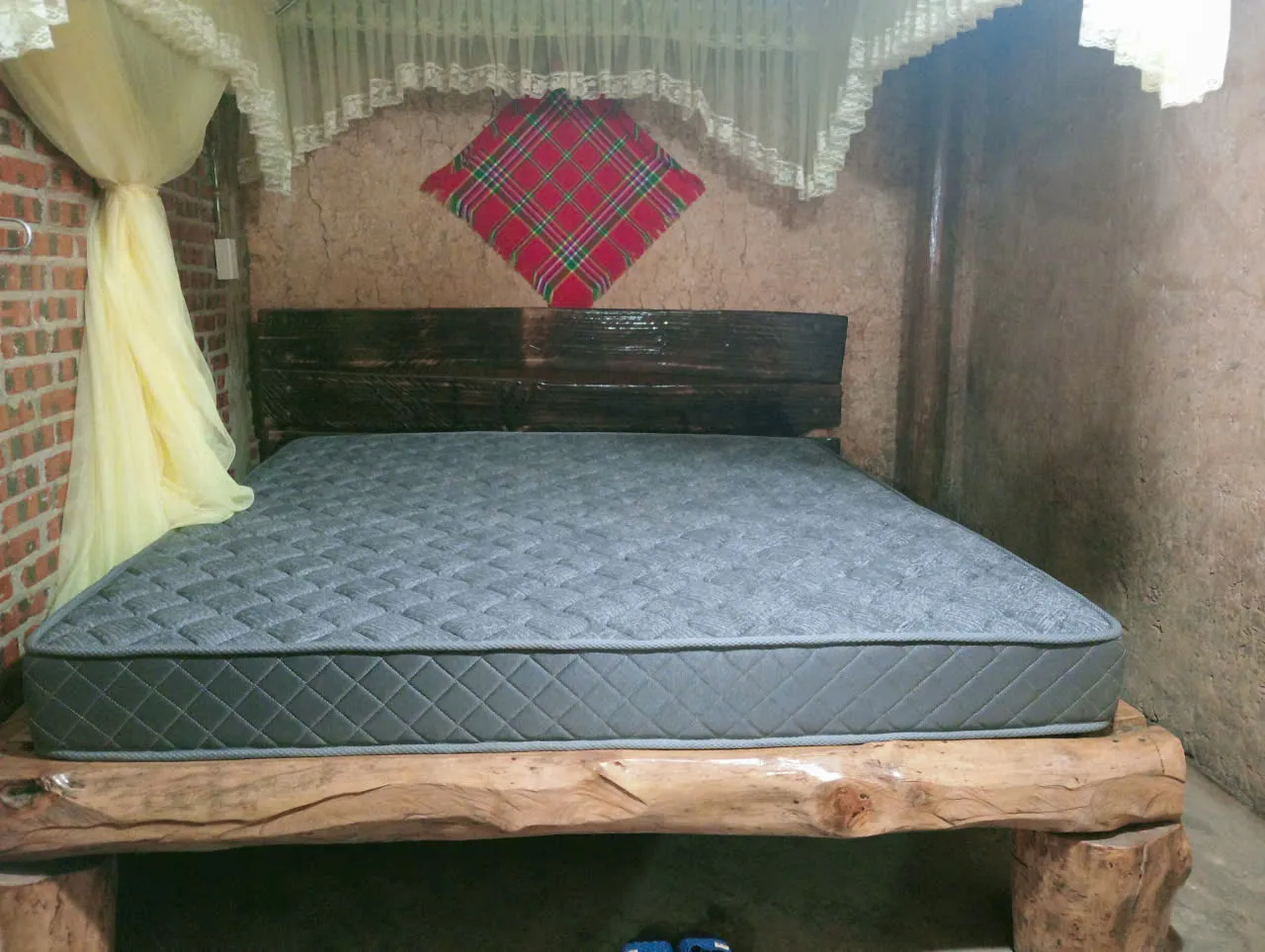 A simple homestay sleeping room with bedding in Lo Lo Chai — shared or private arrangement depends on the departure.