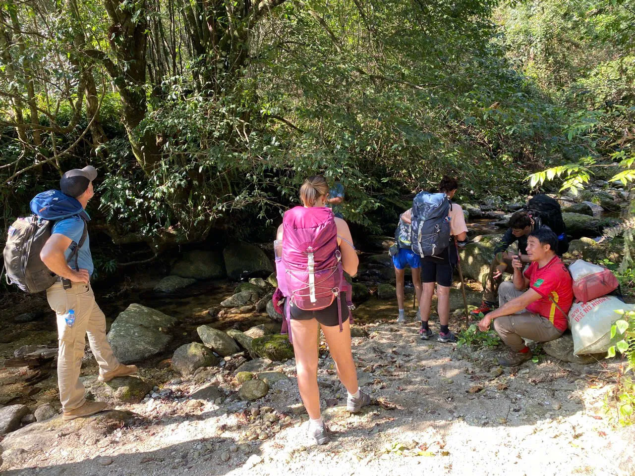 Picnic spread laid out on the forest trail during a trekking day on Tay Con Linh.